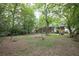 Spacious backyard with mature trees and lush lawn, offering a private outdoor area at 2383 N Decatur Rd, Decatur, GA 30033