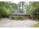 Charming brick home showcasing a concrete driveway, neatly trimmed hedges, and a freshly mowed lawn, perfect for curb appeal at 2383 N Decatur Rd, Decatur, GA 30033