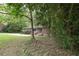 A cozy, red-brick home with a well-kept lawn surrounded by lush green trees at 2383 N Decatur Rd, Decatur, GA 30033