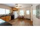 Bright kitchen featuring wooden cabinets, black countertops, hardwood floors, and a cozy dining nook at 2383 N Decatur Rd, Decatur, GA 30033