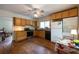 Sunny kitchen with wooden cabinets, black appliances, and beautiful hardwood floors, including a cozy breakfast nook at 2383 N Decatur Rd, Decatur, GA 30033
