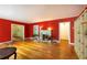Open living room featuring hardwood floors, red walls, a fireplace, and lots of natural light at 2383 N Decatur Rd, Decatur, GA 30033