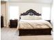 Bedroom showcasing a large bed with a tufted headboard and two side tables at 3830 Kittery Pt, Snellville, GA 30039