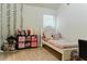 Bright bedroom with a white bed frame, complemented by a functional desk setup and soft, neutral carpet at 3830 Kittery Pt, Snellville, GA 30039