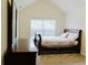 Serene bedroom with soft natural light, a comfortable bed, and a dresser, creating a cozy retreat at 3830 Kittery Pt, Snellville, GA 30039