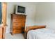 The bedroom features a wooden dresser and bed, paired with neutral walls and carpet for a serene atmosphere at 3830 Kittery Pt, Snellville, GA 30039