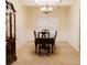 Traditional dining room with elegant wainscoting, carpet, and classic chandelier at 3830 Kittery Pt, Snellville, GA 30039