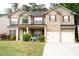 Charming two-story brick home with a well-manicured lawn and attached two-car garage at 3830 Kittery Pt, Snellville, GA 30039
