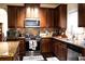 Spacious kitchen with granite countertops, stainless steel appliances, and custom cabinetry at 3830 Kittery Pt, Snellville, GA 30039