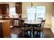 Cozy eat-in kitchen features a granite countertop, dark wood cabinets, and large window at 3830 Kittery Pt, Snellville, GA 30039