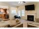 Relaxing living room with a fireplace, tv, and open layout to kitchen and dining area at 3830 Kittery Pt, Snellville, GA 30039