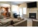 Bright living room with a fireplace, tv, and open layout to kitchen and dining area at 3830 Kittery Pt, Snellville, GA 30039