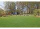 Spacious backyard with lush green lawn and mature trees, offering a serene outdoor space at 699 Rollingwood Dr, Stone Mountain, GA 30087