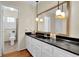 Bathroom featuring a large mirror, modern vanity, and a view into an adjacent full bath at 699 Rollingwood Dr, Stone Mountain, GA 30087