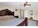 Bedroom with a decorative wood bed frame, side table, and bathroom access at 699 Rollingwood Dr, Stone Mountain, GA 30087