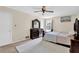 Bedroom boasting a wooden dresser, ceiling fan, and natural light from the window at 699 Rollingwood Dr, Stone Mountain, GA 30087