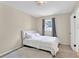 Cozy bedroom featuring neutral walls, plush rug, and a comfortable bed with white linens at 699 Rollingwood Dr, Stone Mountain, GA 30087