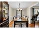 Elegant dining room with a large wood table, chandelier, and natural light at 699 Rollingwood Dr, Stone Mountain, GA 30087