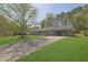 Single-story brick home with covered parking, blue trim, and a large front yard at 699 Rollingwood Dr, Stone Mountain, GA 30087