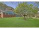 Brick home with blue trim, shutters, and covered carport on a well-maintained lawn at 699 Rollingwood Dr, Stone Mountain, GA 30087
