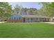 Charming single-story brick home with a well-manicured lawn and covered parking area at 699 Rollingwood Dr, Stone Mountain, GA 30087
