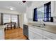 Kitchen featuring white cabinets, stainless steel appliances, and dining area at 699 Rollingwood Dr, Stone Mountain, GA 30087