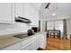 Bright kitchen with white cabinets, modern appliances, and dining table under window at 699 Rollingwood Dr, Stone Mountain, GA 30087