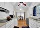 Bright kitchen featuring white cabinets, modern appliances, and an adjacent dining area at 699 Rollingwood Dr, Stone Mountain, GA 30087