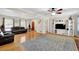 Spacious living room with hardwood floors, black leather sofas, and natural light at 699 Rollingwood Dr, Stone Mountain, GA 30087