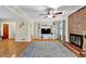 Cozy living room featuring a brick fireplace, built in shelving and hardwood floors at 699 Rollingwood Dr, Stone Mountain, GA 30087