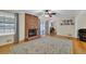Inviting living room with a brick fireplace and access to the dining area at 699 Rollingwood Dr, Stone Mountain, GA 30087