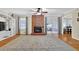 Spacious living room with brick fireplace, hardwood floors, and sliding glass doors at 699 Rollingwood Dr, Stone Mountain, GA 30087