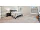 Neutral bedroom featuring soft carpet, a classic black bed frame, and ample natural light at 10265 Grandview Sq, Johns Creek, GA 30097