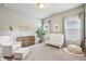 Bright bedroom features a comfortable chair and baby furniture at 10265 Grandview Sq, Johns Creek, GA 30097