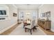 Charming dining room featuring hardwood floors, a farmhouse table, and shiplap accent wall, creating a cozy atmosphere at 10265 Grandview Sq, Johns Creek, GA 30097