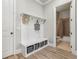 Functional entryway features a built-in bench with storage and easy access to a convenient half bath at 10265 Grandview Sq, Johns Creek, GA 30097