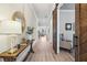 Elegant hallway featuring hardwood floors, stylish decor, and a view into the living room at 10265 Grandview Sq, Johns Creek, GA 30097