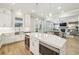 The bright kitchen features an island with built in microwave and wine cooler, and is open to the living room at 10265 Grandview Sq, Johns Creek, GA 30097