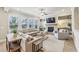 Bright and spacious living room featuring a fireplace, large windows, and comfortable seating at 10265 Grandview Sq, Johns Creek, GA 30097