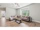 Spacious living area with hardwood floors, recessed lighting, large window, and a comfortable gray sectional sofa at 10265 Grandview Sq, Johns Creek, GA 30097