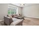 Inviting living room filled with natural light, hardwood floors, and comfortable gray couches with accent pillows at 10265 Grandview Sq, Johns Creek, GA 30097