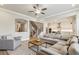 Open-concept living room showcases a staircase, large sofa, and a glimpse of the modern kitchen at 10265 Grandview Sq, Johns Creek, GA 30097