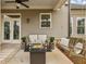 Relaxing covered patio featuring comfortable seating, a cozy fire pit, and a charming porch swing at 10265 Grandview Sq, Johns Creek, GA 30097