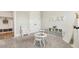 Spacious playroom with a small table and chairs, play kitchen, and plenty of natural light for imaginative play at 10265 Grandview Sq, Johns Creek, GA 30097