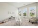 Bright playroom with natural light, a small table and chairs, and a cozy chair with a view of the backyard at 10265 Grandview Sq, Johns Creek, GA 30097