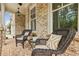 Cozy front porch showcases decorative brickwork and charming wicker seating at 10265 Grandview Sq, Johns Creek, GA 30097