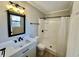 Updated bathroom featuring a modern vanity, mirror, and shower with tile surround at 134 Carrollwood Dr, Fayetteville, GA 30215