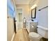 Stylish bathroom showcasing wood flooring, modern vanity and fixtures, and a window at 134 Carrollwood Dr, Fayetteville, GA 30215