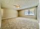 Carpeted bedroom featuring neutral walls and a ceiling fan at 134 Carrollwood Dr, Fayetteville, GA 30215
