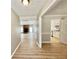 Bright hallway featuring wood floors, with views of the living room and kitchen area at 134 Carrollwood Dr, Fayetteville, GA 30215